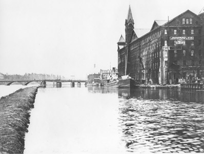 Located at the upper tidal and navigation limit of the Raritan River, New Brunswick’s factory district fronted upon the Delaware and Raritan Canal downstream of the Deep Lock (Lock No. 13).  In addition to Johnson & Johnson, New Brunswick was also the location of the Janeway & Co. wallpaper factory (reputedly the largest wallpaper factory in the nation), as well as factories which produced rubber goods, hosiery, shoes, carriages and machinery.  Although some historians and writers have commented that the construction of the Delaware and Raritan Canal retarded economic growth by diminishing the importance of the city as a trans-shipment point, the canal did provide the New Brunswick’s industries with a source of water power and a steady supply of anthracite coal from Pennsylvania to fuel their businesses. 